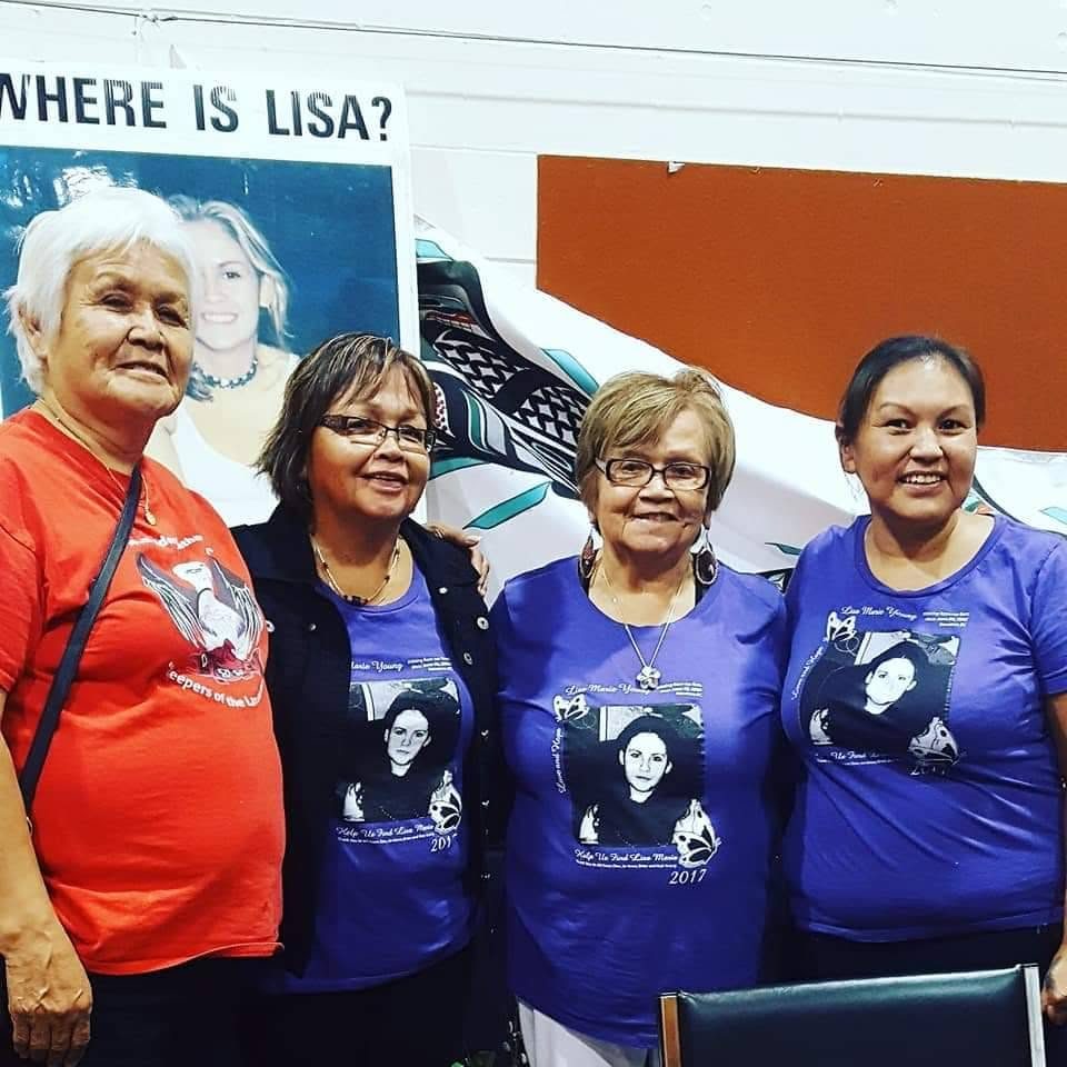 Lisa's family marching together in shirts bearing her portrait