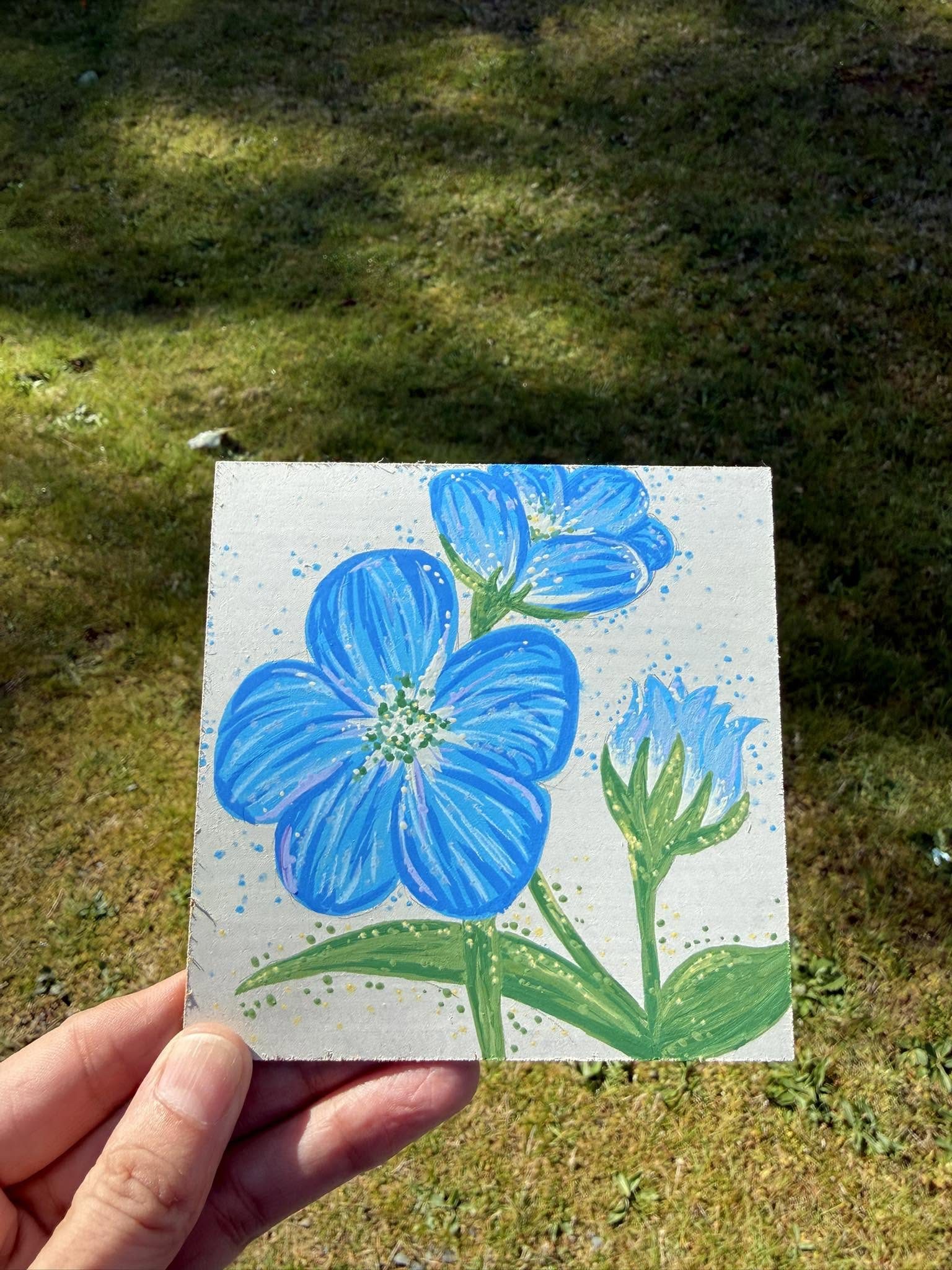 A watercolour painting of blue flowers by local high school students